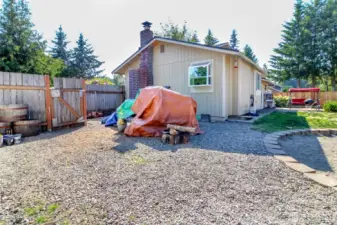 Huge side yard which is gravel and there is a shed with power in it for your hobby projects