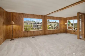 Spacious living room with big double pane windows. Lots of natural light.