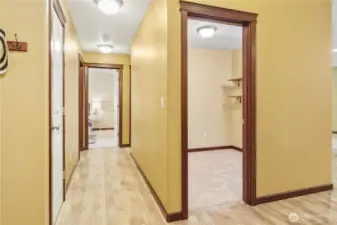 Hall entry to large walk-in closet. An additional closet on left side of hallway with 2 bedrooms and full bath down the hallway.