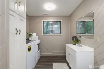 Outside of the family room is a 3/4 bathroom with washer/dryer that convey with the property.