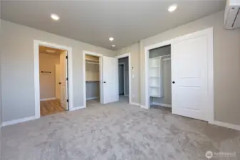 Primary suite has two closets with quality built in shelves