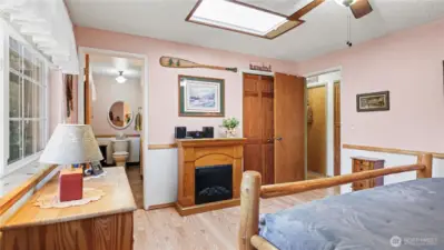 Upstairs primary bedroom features skylight and en-suite bathroom.