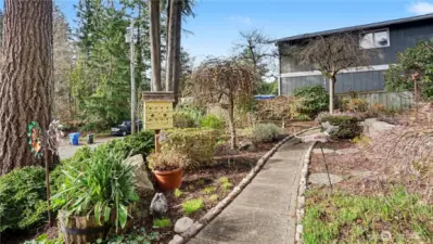 Mature landscaping surrounding the front yard walkways add charm and greenery.