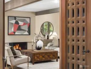 Enter the elegant and spacious living room through custom wood doors
