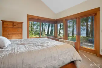 Additional bedroom with vaulted ceiling, a row of windows to frame the amazing view, and French doors to the patio.