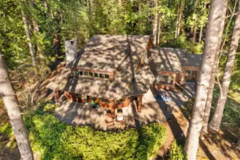 Aerial view. Nestled in a beautiful treed setting with a wonderful northwest feel. An abundance of windows to maximize the stunning views.