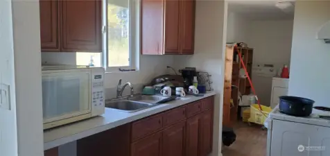 Kitchen with view of back yard.  Utility room off kitchen area.