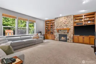 Spacious living room with gas fireplace, gorgeous built-ins and a wall of windows to let the light in