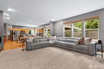 Living room opens to dining and kitchen and looks out to backyard retreat