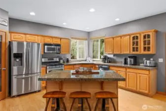 Open concept kitchen with stainless appliances and an abundance of cabinetry