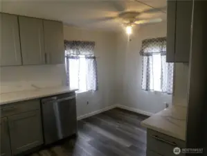 You are standing at the sink looking at the front door.