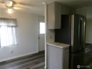 You are standing at the sink looking at the front door.