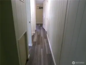 Hall leads to small bedroom, bathroom, main bedroom and laundry room.