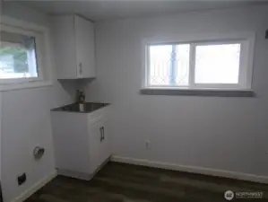 Laundry room with washer/dryer hook up and handy sink and cabinet.