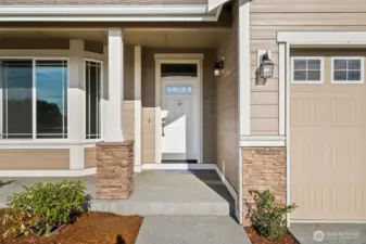 Our Redwood one story floor plan has the perfect covered porch entry with stone accents to welcome you and your guests.