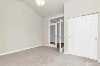Off the front entry hall,  glass French doors open into what could be a den/office space or a 3rd bedroom.