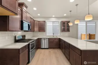 Stainless steel appliances include double oven range, dishwasher and microwave.