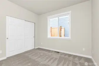 Adjacent to full bathroom is the second bedroom featuring a large reach-in closet.