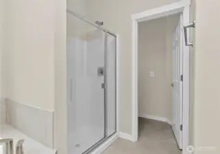 Primary bathroom offers a standard walk-in shower with glass door and a separate, private water closet.