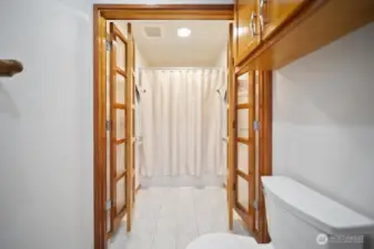 Guest full bath with French privacy doors.