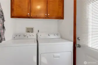 Utility and mud room with access to back .yard patio. W/D are only a few years old.