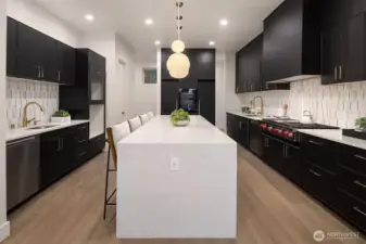 Sleek and functional, the chef's kitchen centers around a striking waterfall island - perfect for cooking, gathering, and entertaining in style.