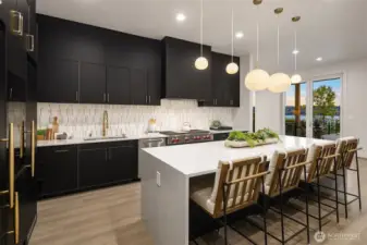 Cook and entertain with inspiring lake views, framed by the kitchen's sleek design and expansive sliding doors