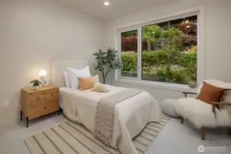 One of four upper-level bedrooms, this serene retreat connects to a Jack-and-Jill full bath and overlooks lush, landscaped gardens