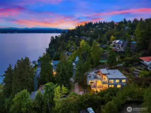 Perched above Lake Washington, this modern masterpiece captures breathtaking sunsets and sweeping water views from an enviable west-facing vantage