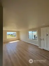 Living room and front door all new laminate flooring, trim and recess lighting