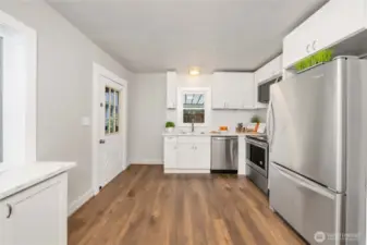 Entering the kitchen from the dining room. Another access is to the right of the fridge.