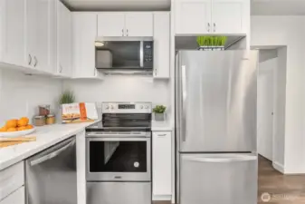 Another view of the kitchen appliances and cabinets. Quartz counters are gorgeous!