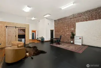 Front room designed with cement floors and brick walls