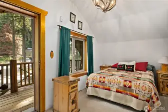 Upstairs bedroom #1. It has lovely deck to enjoy beautiful nature right from your bedroom.