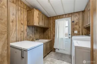 Laundry room with utility sink and access to back deck