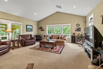 Oversized great room boasts vaulted ceilings, cozy pellet stove, Milgard Windows w/picture glass above and sliding function below allows for fresh PNW crosswind when desired!