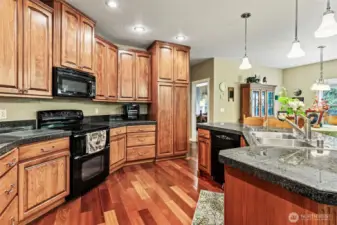 Spacious kitchen with efficient design and ample storage. Beech cabinetry offers pullouts and other organizational features.