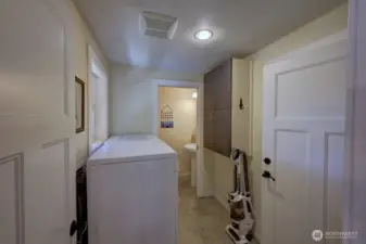 Laundry room with access to the garage and 1/2 bath.