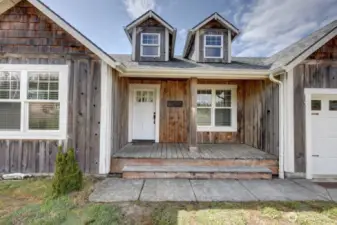 Welcome home. This covered front porch is perfect for sitting and watching the world go by.