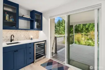 Full wet bar & drink fridge, with sliding doors leading to back deck & pool!