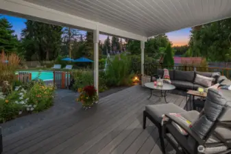 Covered outdoor deck overlooking pool area