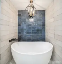Elegant floating tub & well-appointed chandelier