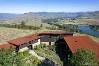 Overlooking Pearrygin Lake with dramatic mountain and valley views and buffered by public land on two sides.