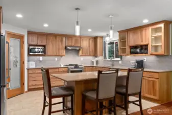 Pretty redone kitchen with island and pull out shelving.