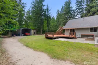 Side driveway leads to the back and to the metal outbuilding to park the toys.