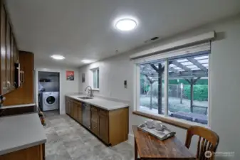 Updated galley kitchen with eating space, newer cabinetry, appliances, and countertops!