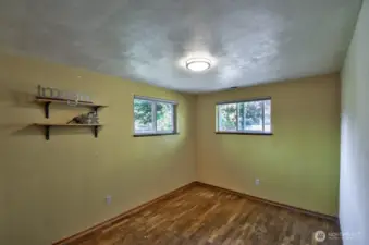 On the other side of the home, original hardwood floors in the two additional bedrooms. This one, at the back of the house, features cedar lined closet.