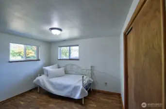 Spacious front bedroom with original hardwood floors and large, cedar-lined closet.