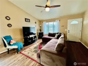 Laminate floors and ceiling fan in living room