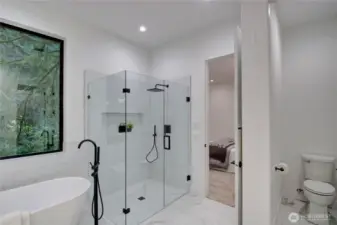 Luxury Primary Bathroom with glass enclosed shower and separate soaking tub.